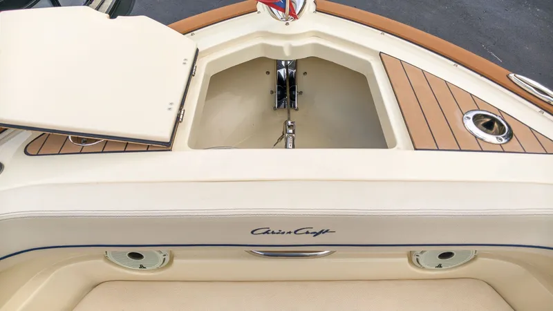 Slide: The Image of The 2022 Chris-Craft Calypso 27 features an open storage area with wood trim and an anchor. - 22
