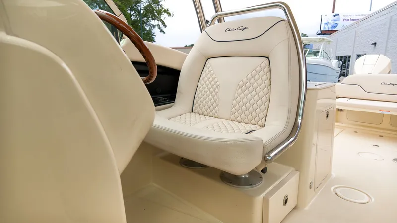 Slide: The Image of The interior of a 2022 Chris-Craft Calypso 27 with elegant, upholstered seating. - 23