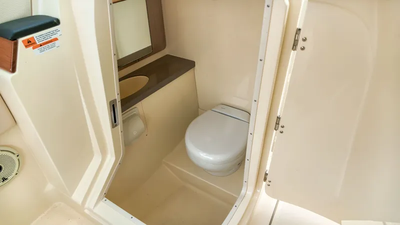 Slide: The Image of The image shows a compact boat toilet with a sink and mirror. - 15