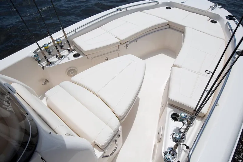 Slide: The Image of Manufacturer Provided Image: 2023 Grady-White 251 Coastal Explorer boat interior with cushioned seating and fishing rod holders. - 2