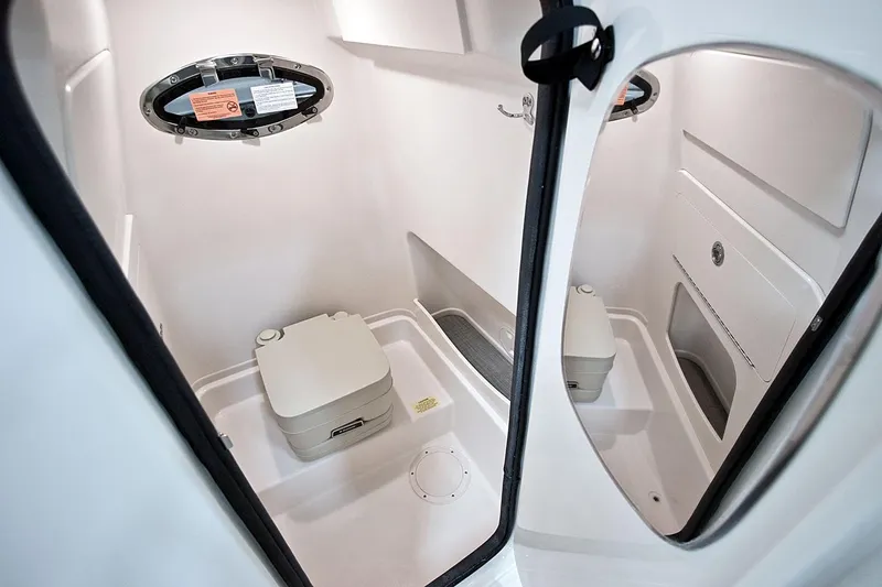 Slide: The Image of Manufacturer Provided Image: 2023 Grady-White 251 Coastal Explorer boat interior with compact marine toilet. - 10