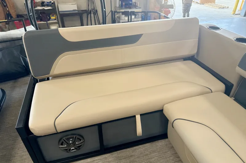 Slide: The Image of 2027 Godfrey Sweetwater 2286 SFL boat interior with beige and gray seating. - 4