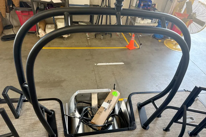 Slide: The Image of Rear view of a 2027 Godfrey Sweetwater 2286 SFL boat in a workshop setting. - 14