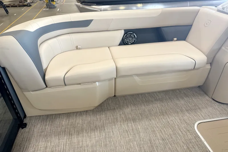 Slide: The Image of 2027 Godfrey Sweetwater 2286 SFL boat interior with beige seating and speaker. - 3