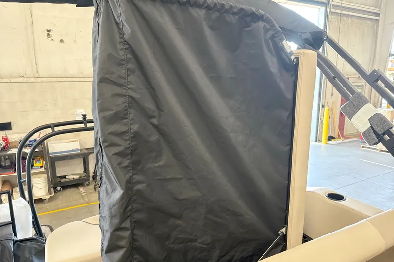 Slide: The Image of 2027 Godfrey Sweetwater 2286 SFL boat interior with protective cover in a workshop setting. - 7