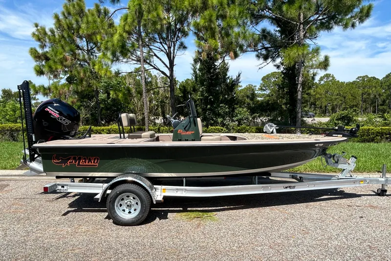 The Image of 2026 Mako 18 Pro Skiff Backwater Edition boat on trailer, parked outdoors. - 0