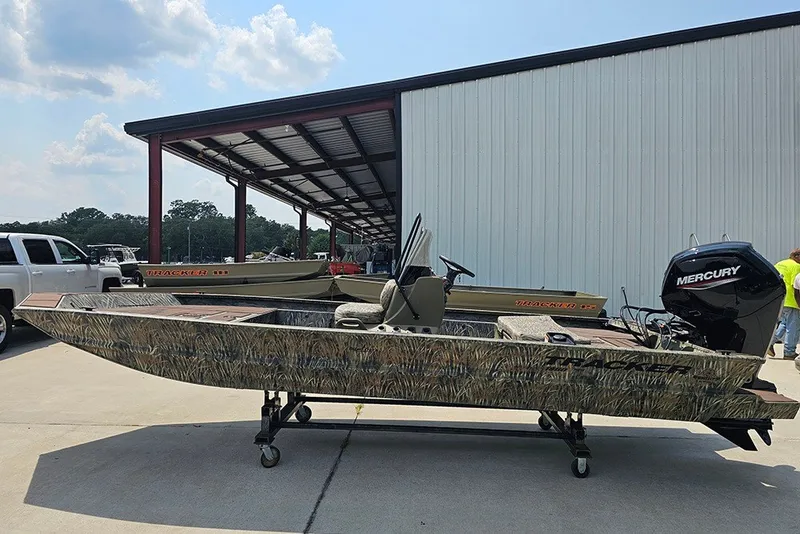 The Image of 2027 Tracker Grizzly 1860 CC boat with Mercury engine, parked outdoors. - 1