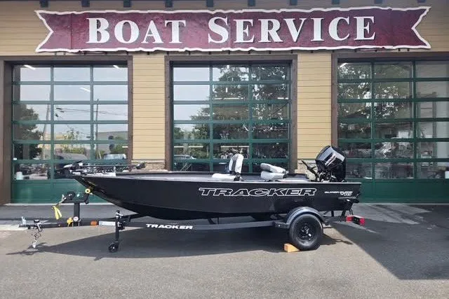 The Image of 2027 Tracker Super Guide V-16 T boat on trailer outside service center. - 0