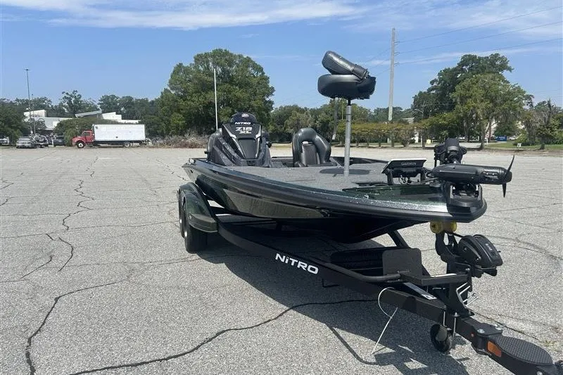 Slide: The Image of 2027 Nitro Z18 XL Pro fishing boat on trailer in parking lot. - 2