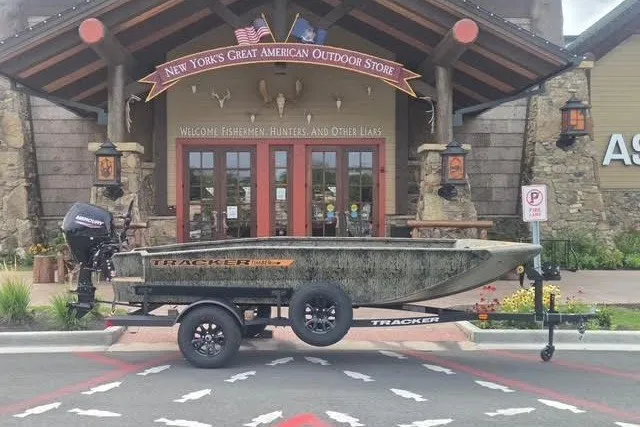 The Image of 2027 Tracker Grizzly 1553 Timber boat displayed outside outdoor store entrance. - 0