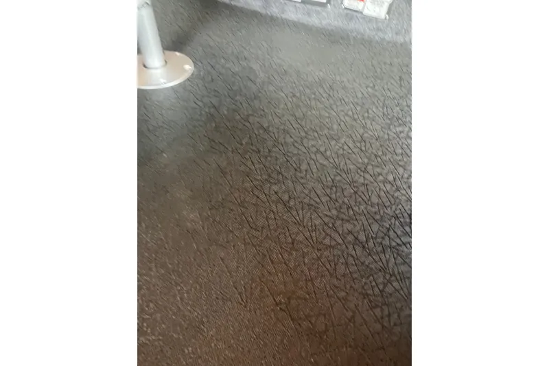 Slide: The Image of Textured floor of a 2027 Tracker Super Guide V-16 T boat interior. - 15