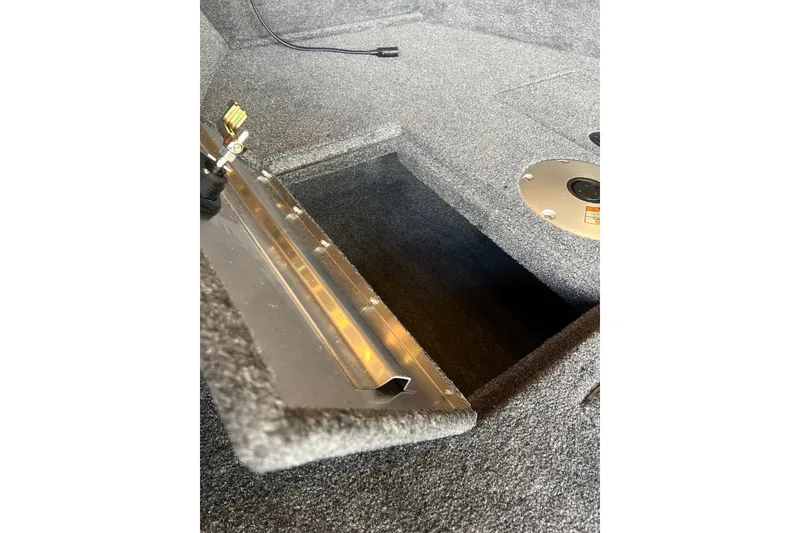Slide: The Image of Carpeted storage compartment in 2027 Tracker Super Guide V-16 T boat interior. - 13