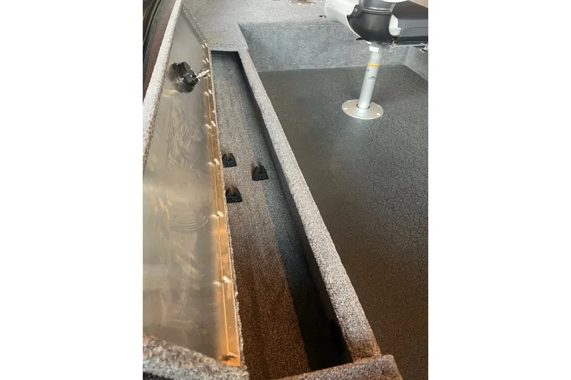 Slide: The Image of Interior view of 2027 Tracker Super Guide V-16 T boat, showcasing storage compartment and seating. - 14