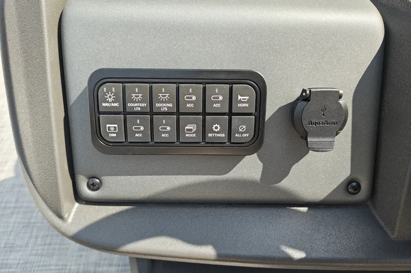 Slide: The Image of Control panel of 2027 Sun Tracker Party Barge 22 DLX with various switches and USB port. - 18