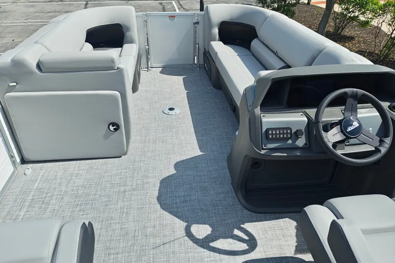 Slide: The Image of Interior view of 2027 Sun Tracker Party Barge 22 DLX with gray seating and steering console. - 26