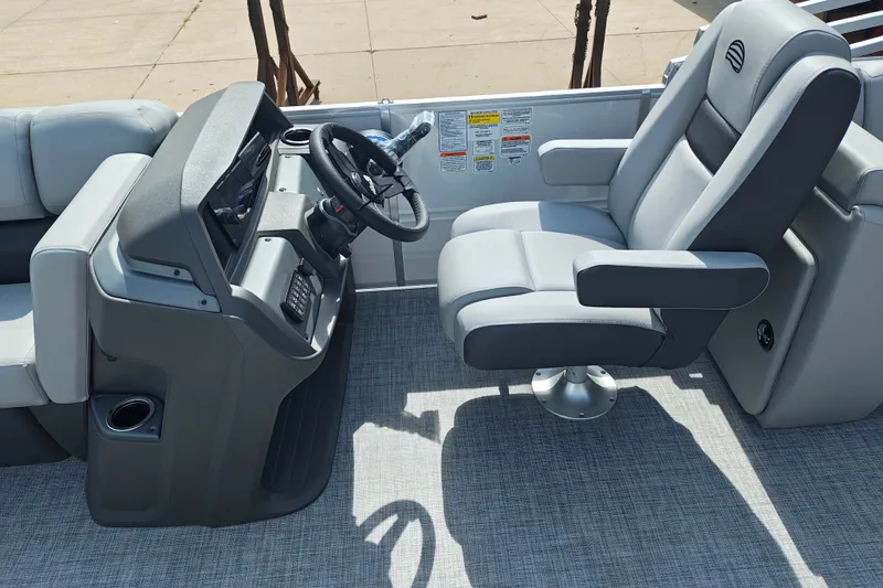 Slide: The Image of Sun Tracker Party Barge 22 DLX 2027 helm with comfortable captain's chair and steering console. - 15
