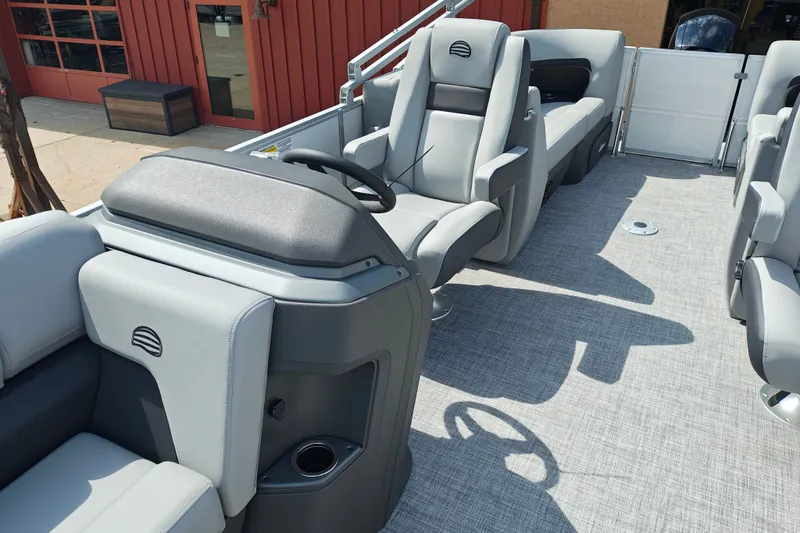 Slide: The Image of 2027 Sun Tracker Party Barge 22 DLX interior with modern seating and steering console. - 14