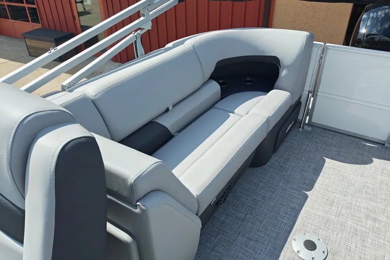 Slide: The Image of 2027 Sun Tracker Party Barge 22 DLX interior with gray seating and cup holders. - 20