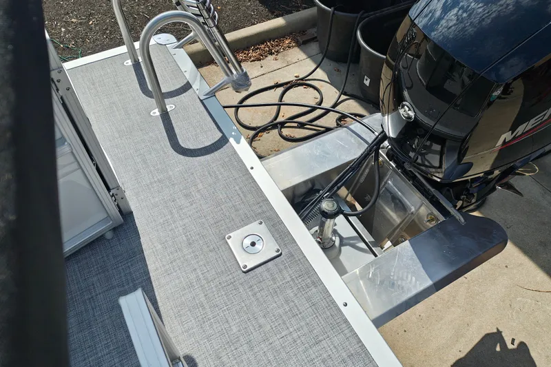 Slide: The Image of 2027 Sun Tracker Party Barge 22 DLX pontoon boat with outboard motor and deck view. - 23