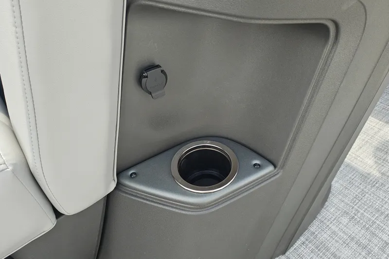 Slide: The Image of Cup holder and USB port on 2027 Sun Tracker Party Barge 22 DLX boat interior. - 16