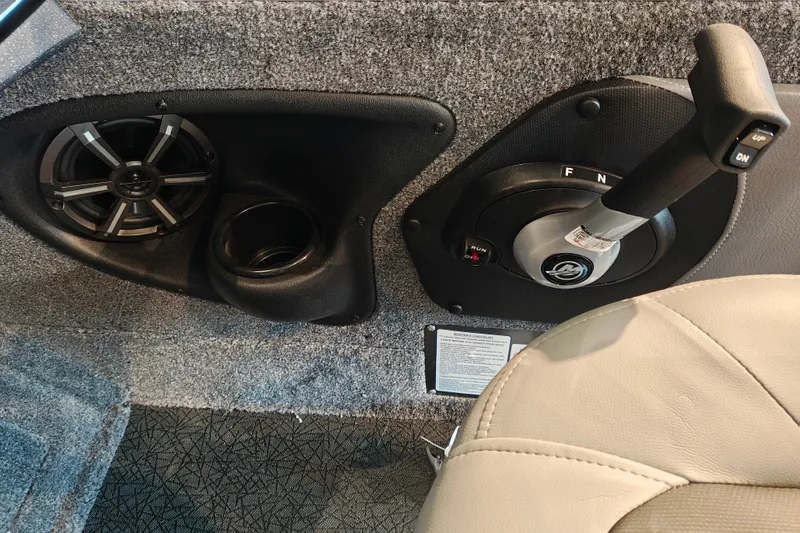 Slide: The Image of 2027 Tracker Targa V-18 WT interior with speaker, cup holder, and control lever. - 15