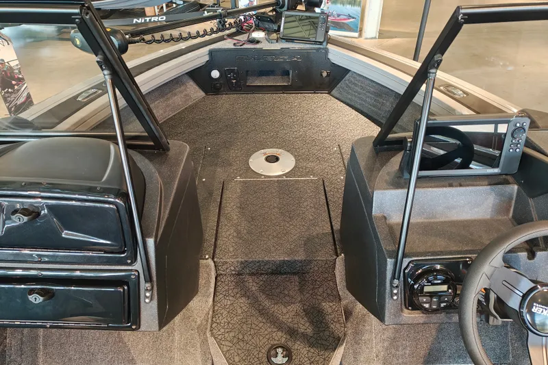 Slide: The Image of 2027 Tracker Targa V-18 WT boat interior with steering wheel and dashboard controls. - 20