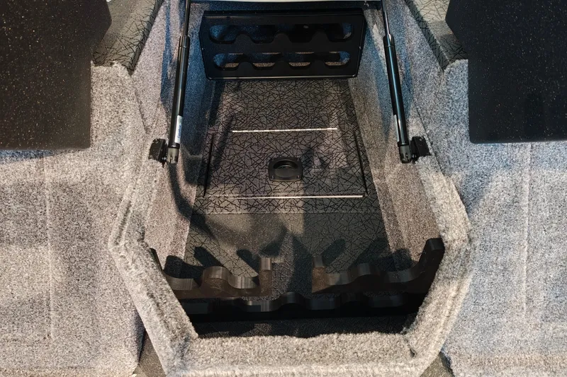 Slide: The Image of 2027 Tracker Targa V-18 WT boat interior storage compartment with carpeted finish. - 21