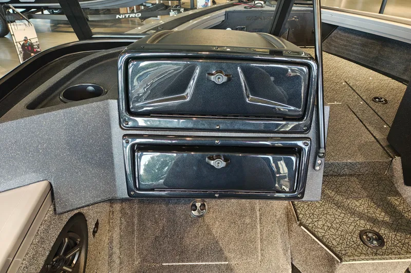Slide: The Image of Interior of 2027 Tracker Targa V-18 WT boat showing storage compartments and seating area. - 18
