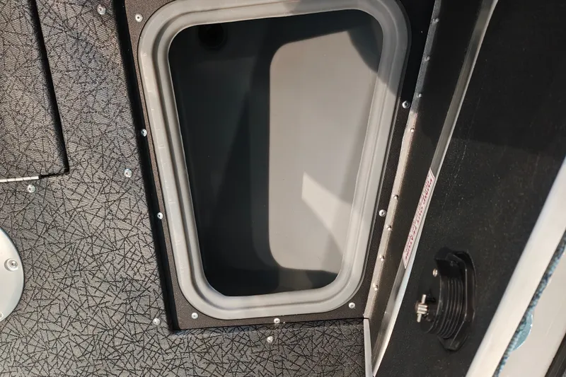 Slide: The Image of Storage compartment in 2027 Tracker Targa V-18 WT boat interior. - 24