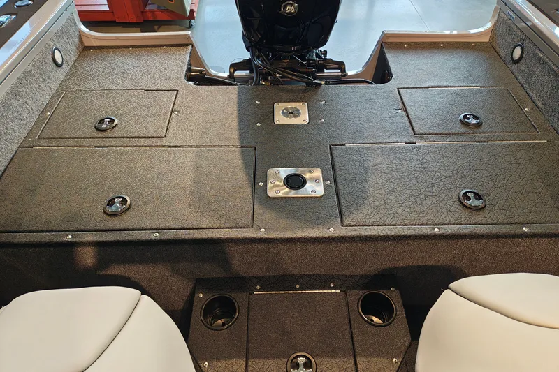 Slide: The Image of 2027 Tracker Targa V-18 WT boat interior with storage compartments and motor. - 32
