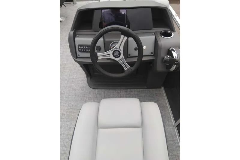 Slide: The Image of 2027 Sun Tracker SportFish 20 DLX boat dashboard with steering wheel and controls. - 34