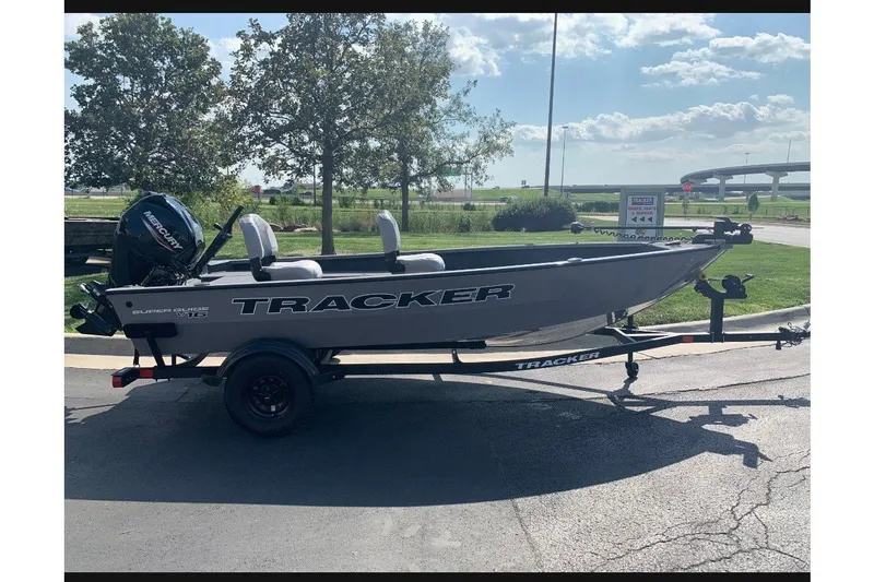 The Image of 2027 Tracker Super Guide V-16 T boat on trailer, parked outdoors. - 0