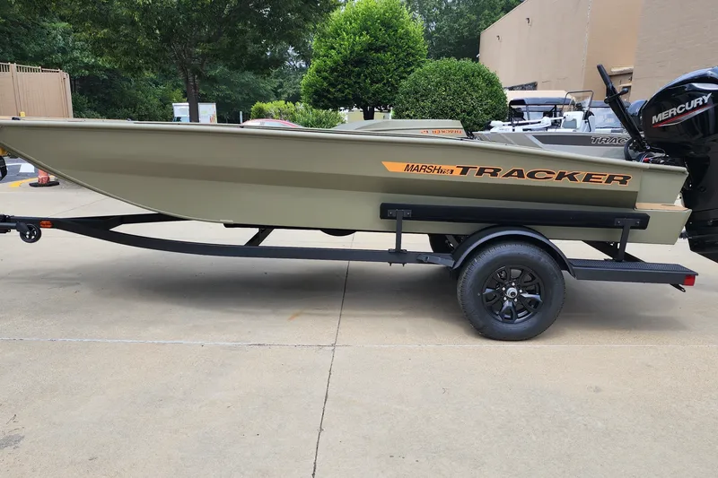 The Image of 2027 Tracker Grizzly 1756 T Marsh boat on trailer, parked outdoors. - 0
