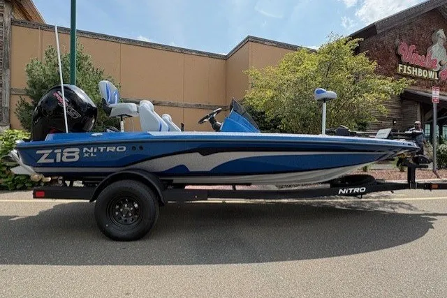 The Image of 2027 Nitro Z18 XL Pro boat on trailer, parked outdoors near a building. - 0