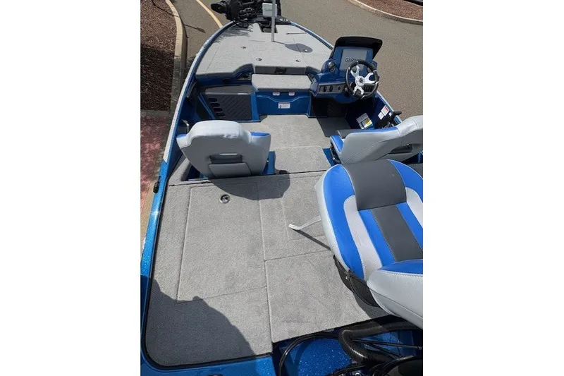 Slide: The Image of 2027 Nitro Z18 XL Pro boat interior with blue and gray seating and steering console. - 4
