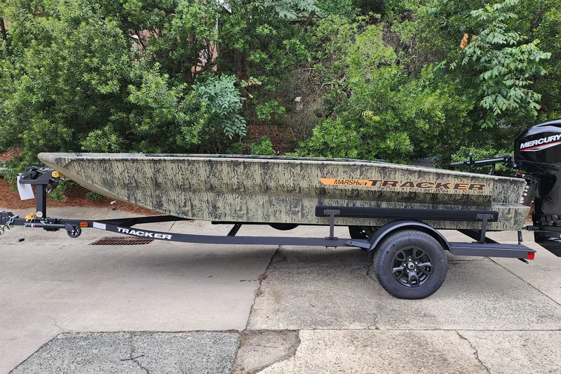 The Image of 2027 Tracker Grizzly 1756 T Marsh boat on trailer, parked outdoors. - 0