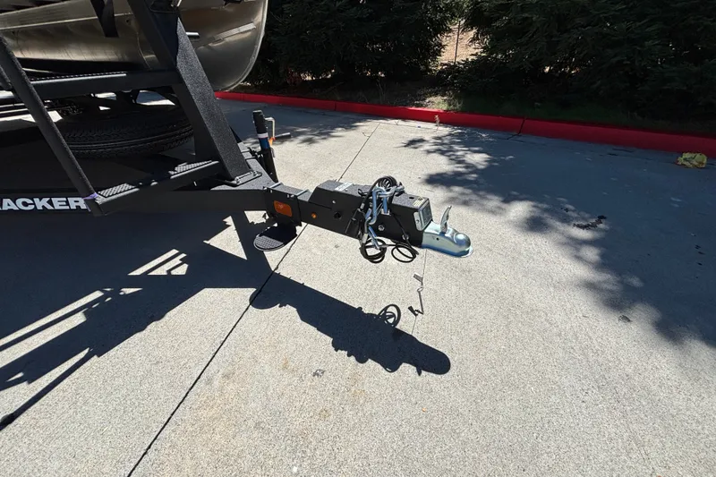 Slide: The Image of Trailer hitch of 2027 Sun Tracker Party Barge 22 DLX on pavement. - 57