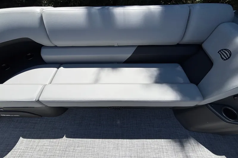 Slide: The Image of Sun Tracker Party Barge 22 DLX 2027, featuring sleek gray seating and cup holders. - 41