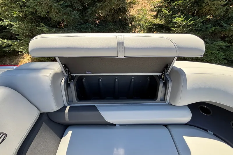 Slide: The Image of 2027 Sun Tracker Party Barge 22 DLX seat storage compartment open, showcasing interior space. - 35