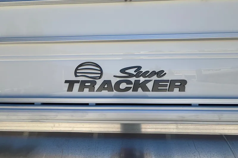 Slide: The Image of 2027 Sun Tracker Party Barge 22 DLX logo on boat exterior. - 17