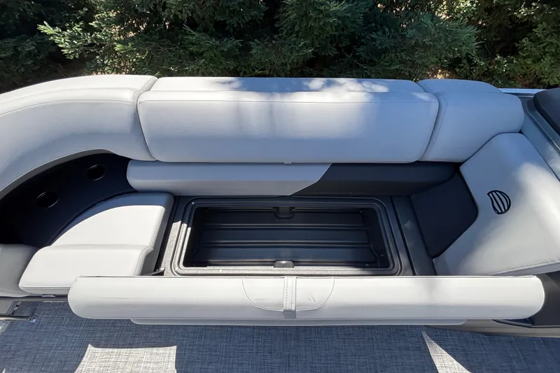 Slide: The Image of 2027 Sun Tracker Party Barge 22 DLX interior seating with storage compartment. - 24