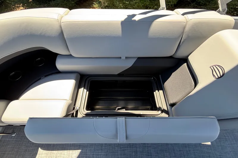 Slide: The Image of Sun Tracker Party Barge 22 DLX 2027 seating with open storage compartment. - 18