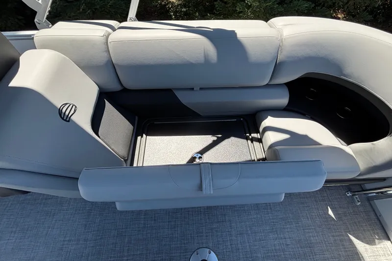 Slide: The Image of 2027 Sun Tracker Party Barge 22 DLX interior seating with storage compartment. - 27