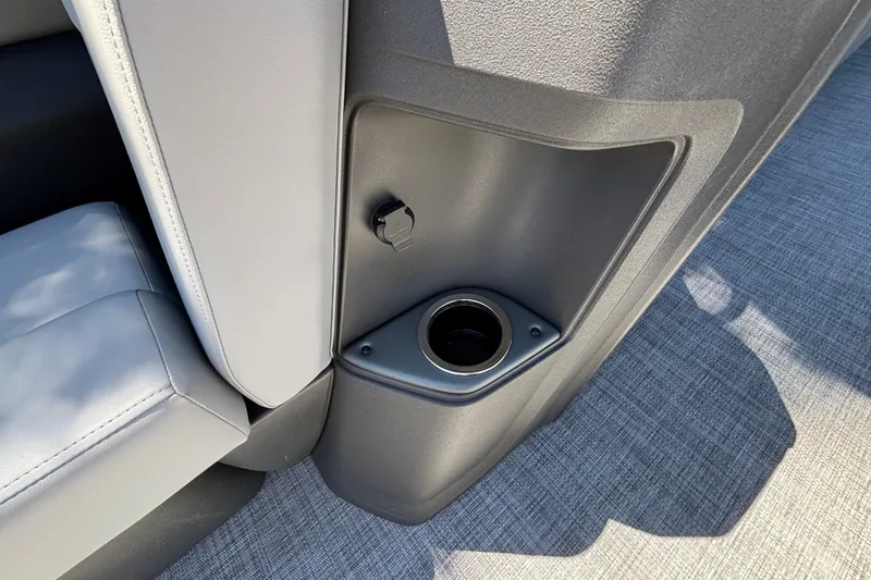 Slide: The Image of Cup holder and USB port on 2027 Sun Tracker Party Barge 22 DLX boat interior. - 44