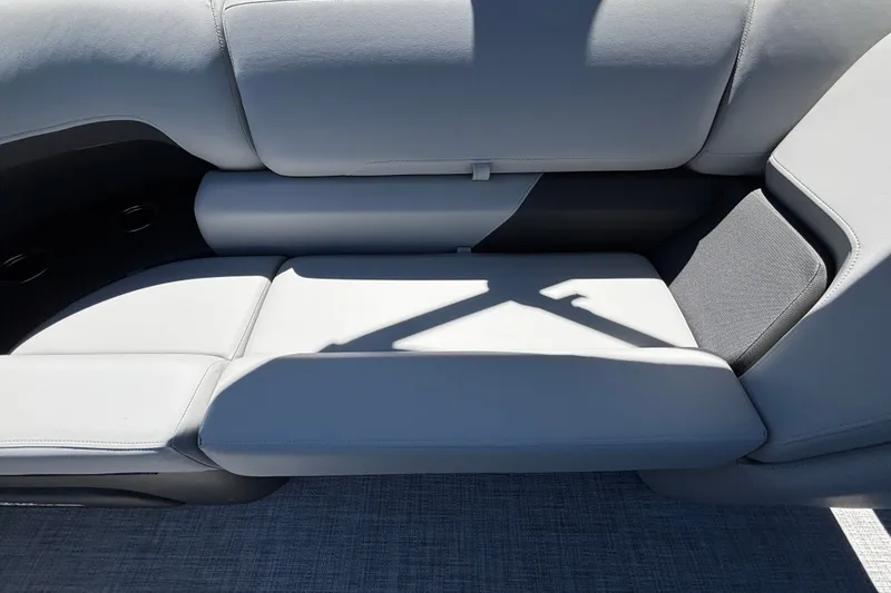 Slide: The Image of 2027 Sun Tracker Party Barge 22 DLX, gray seating with cup holders and textured flooring. - 25