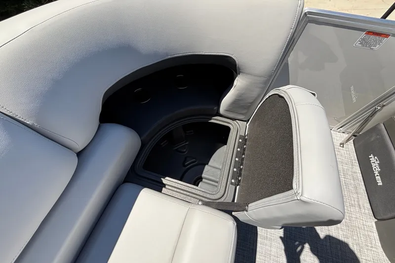 Slide: The Image of 2027 Sun Tracker Party Barge 22 DLX with open storage compartment and cushioned seating. - 20