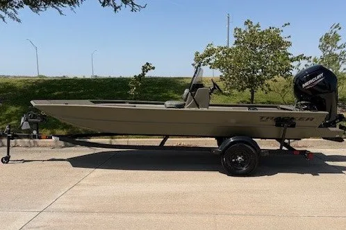 The Image of 2027 Tracker Grizzly 1860 CC boat on trailer, parked outdoors. - 26