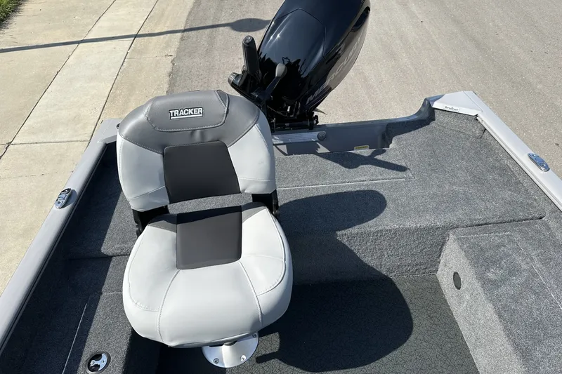 Slide: The Image of Tracker Super Guide V-16 T boat seat and motor, 2027 model, on a sunny day. - 18