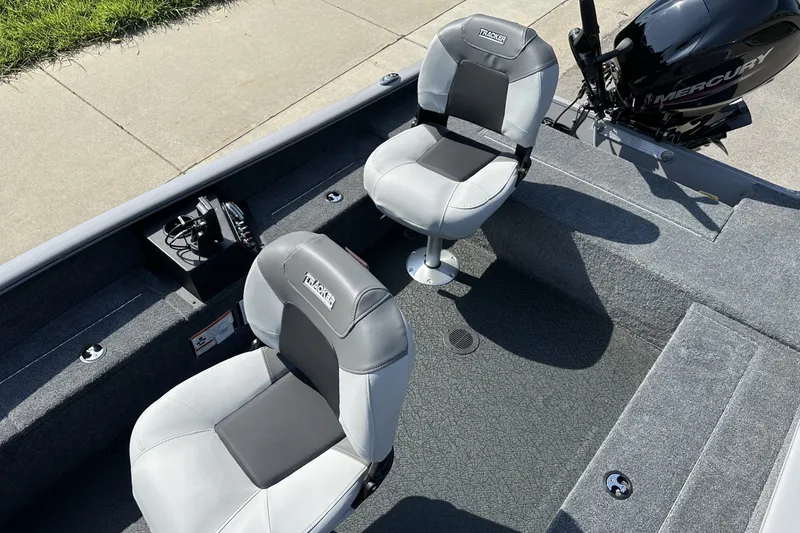 Slide: The Image of 2027 Tracker Super Guide V-16 T boat interior with two seats and Mercury engine. - 19