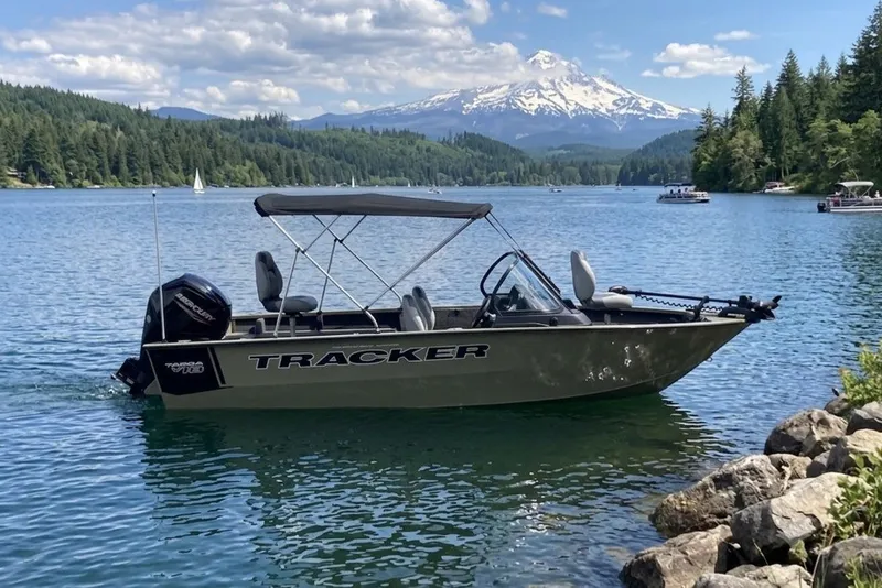 The Image of 2027 Tracker Targa V-18 WT boat on scenic lake with mountain backdrop. - 0